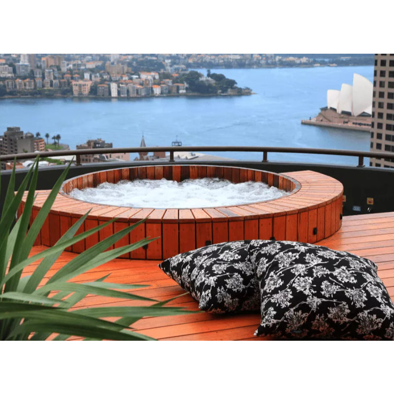 Northern Lights Cedar Hot Tub with jets on Rooftop Patio overlooking Sydney Opera House and Sydney Harbor, Australia.