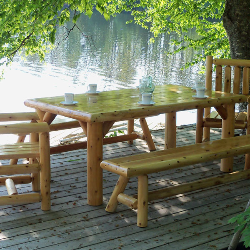 Dundalk Cedar Log Table On Deck Beside a Lake 