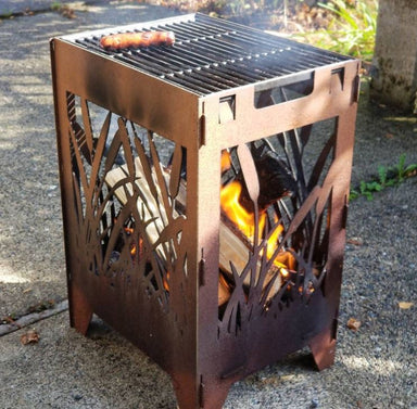 Patinad Reed Fire Pit Grill with fire and hotdog on grill