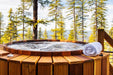 Northern Lights Cedar Hot Tub with jets overlooking trees and ocean