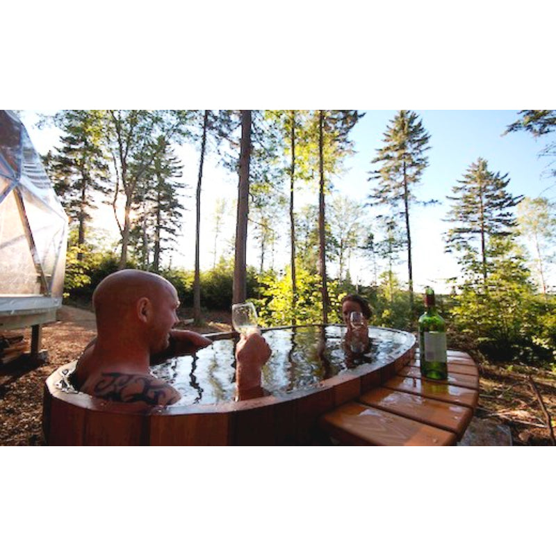Couple enjoying wine in their Ofuro Tub in the forest