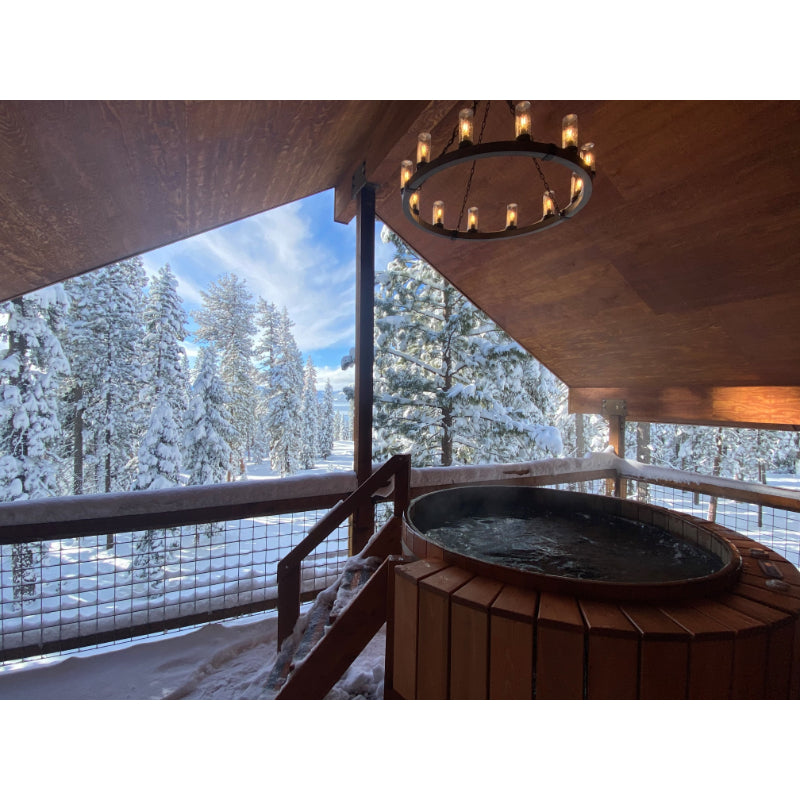 Northern Lights Cedar Hot Tub with jets on back deck overlooking snowy forest
