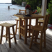 Log Stools around bistro table next to a lake