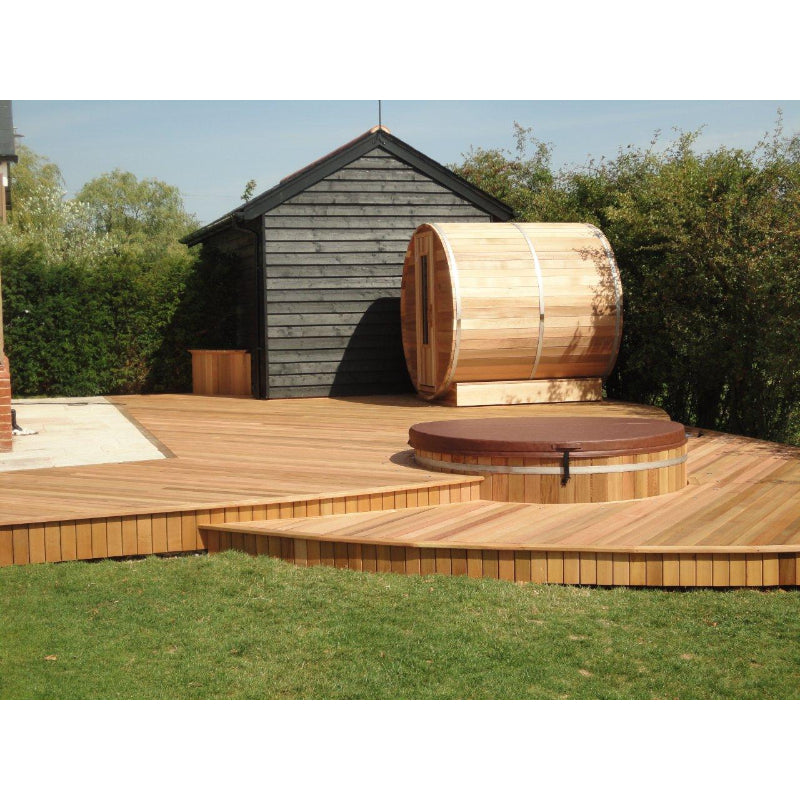 Northern Lights Red Cedar Barrel Sauna and Hot Tub on backyard cedar patio in the sun