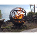 West Coast Fire Pit Sphere with fire next to a lake and picnic table