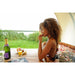 Woman enjoying fruit and champagne while soaking in an Ofuro Tub with rose petals. 